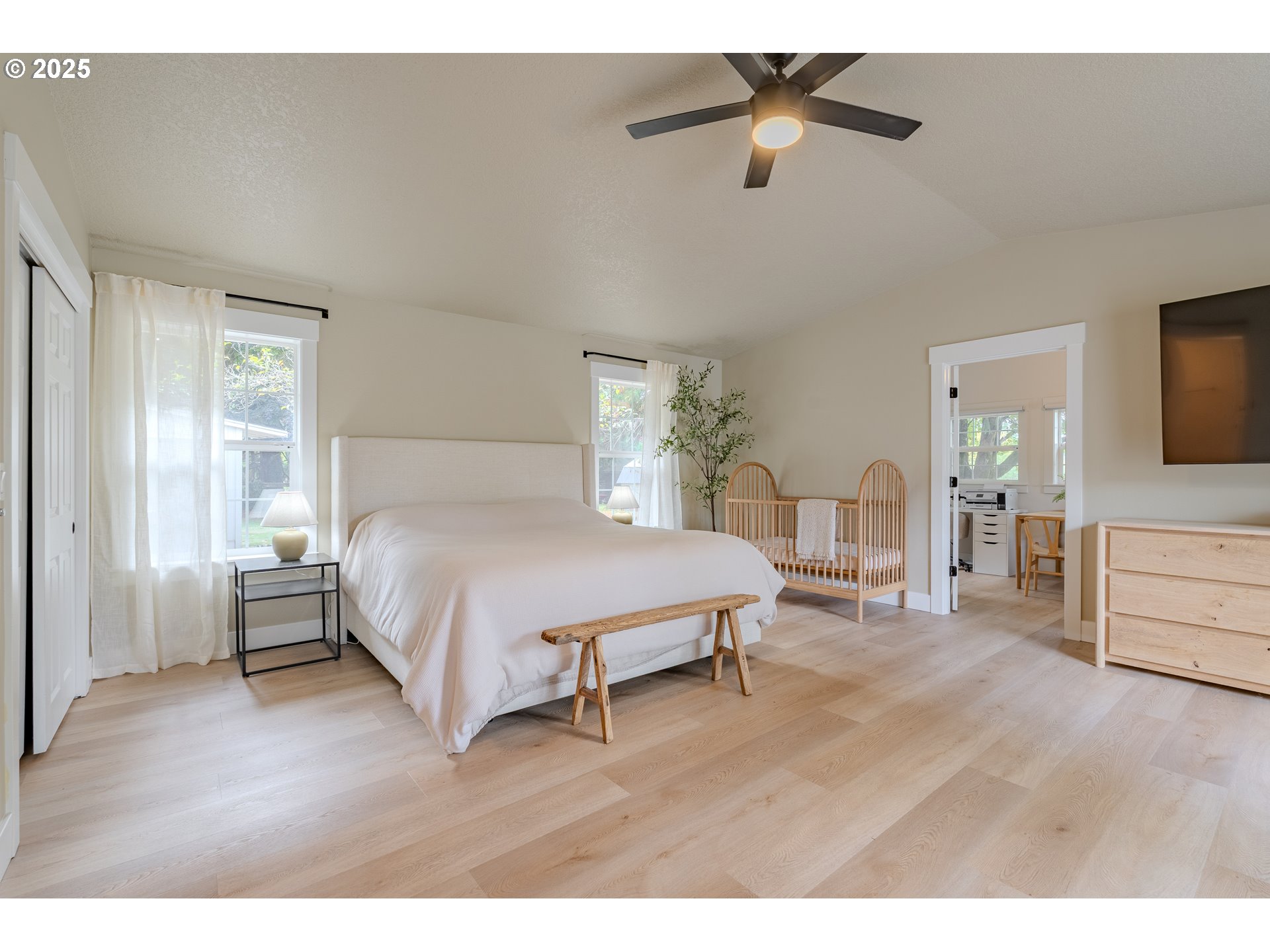20908 Northeast 67th Avenue Battle Ground, WA 98604 - Photo 27 of 47 a spacious bedroom with a bed and a chandelier