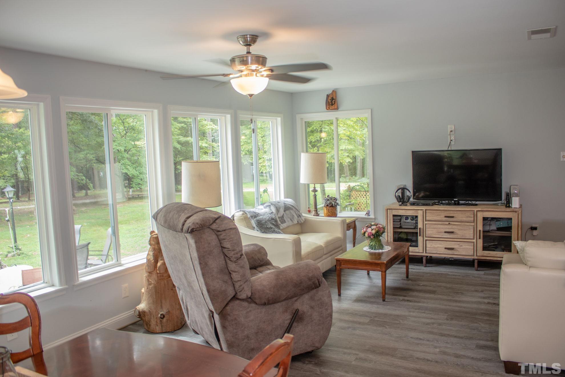 70 Waters Edge Loop Henderson, NC 27537 - Photo 18 of 49 a living room with furniture and a flat screen tv