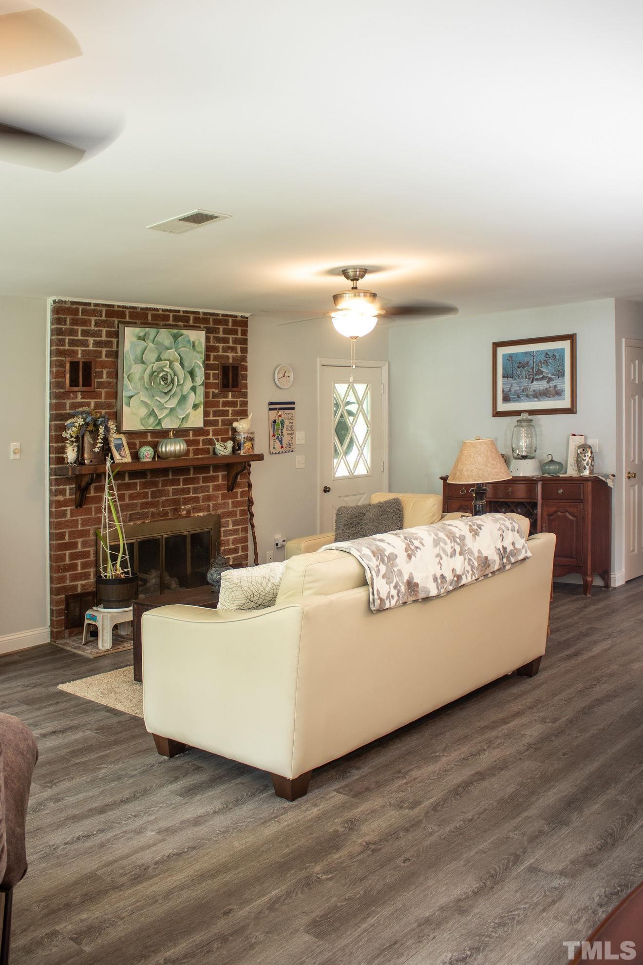 70 Waters Edge Loop Henderson, NC 27537 - Photo 19 of 49 a living room with fireplace furniture and a flat screen tv