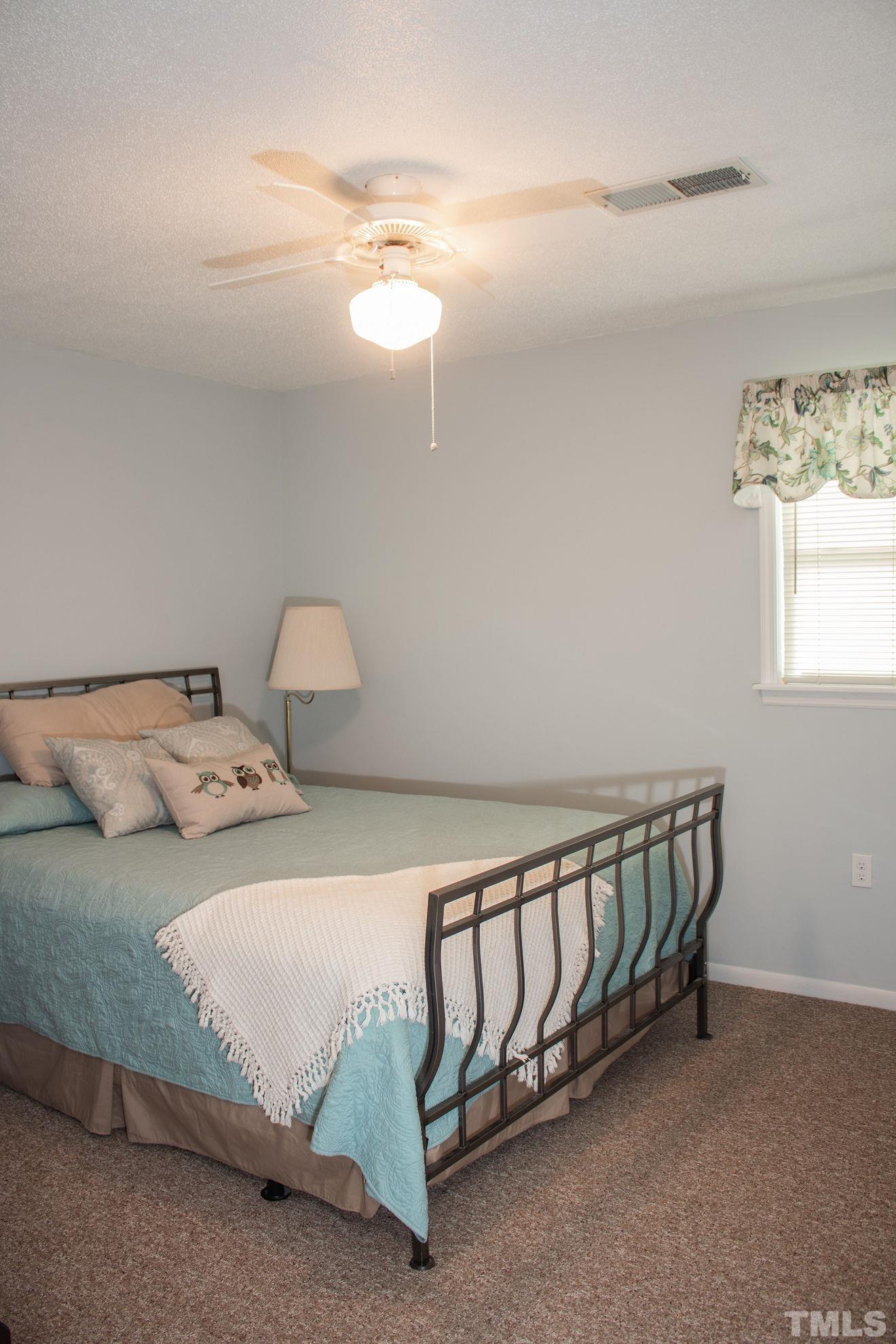 70 Waters Edge Loop Henderson, NC 27537 - Photo 26 of 49 a bedroom with a bed and a window