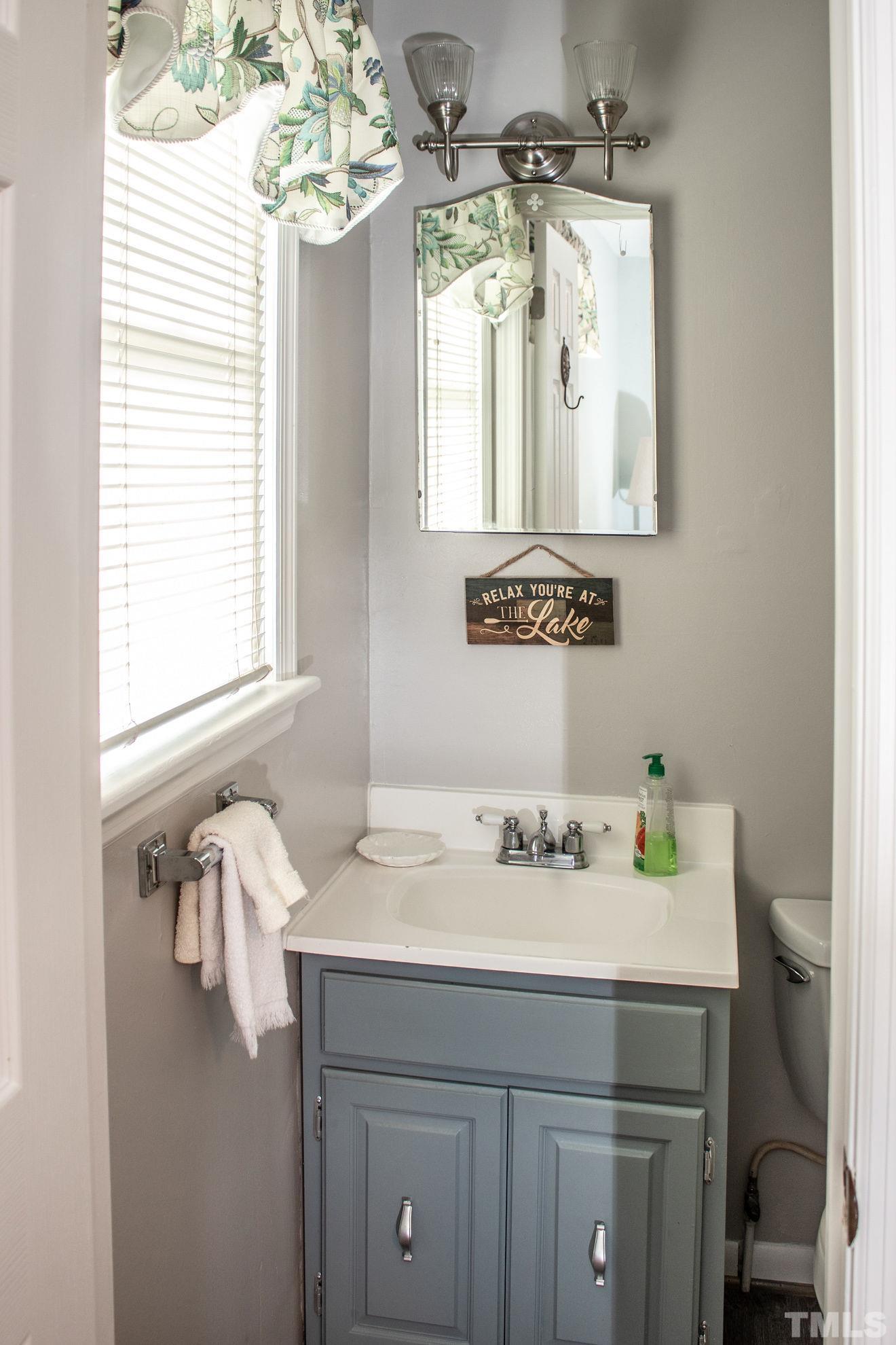 70 Waters Edge Loop Henderson, NC 27537 - Photo 28 of 49 a bathroom with a sink vanity and a mirror