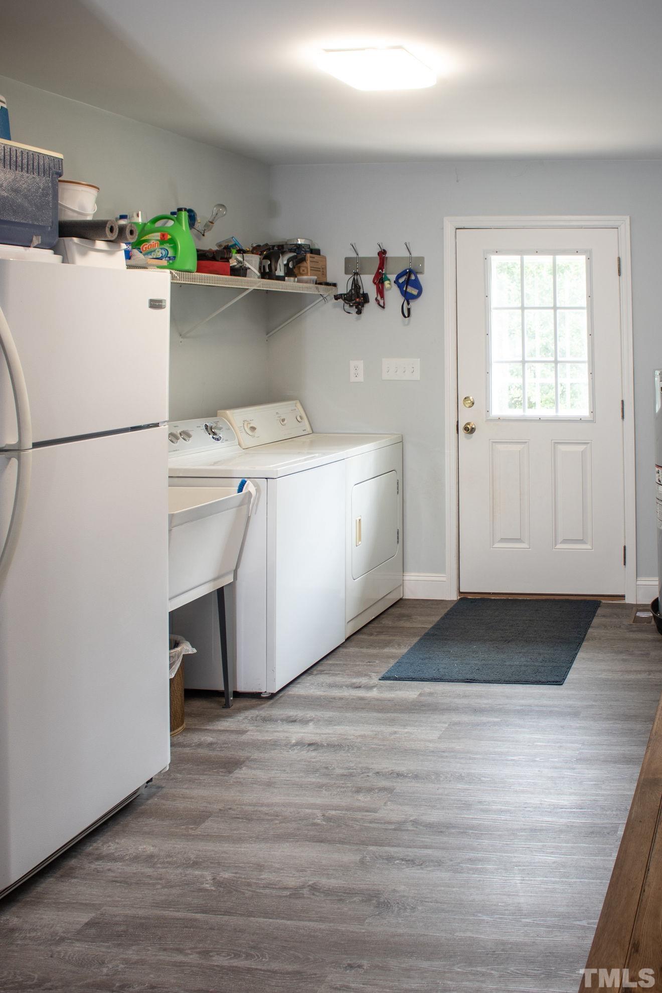 70 Waters Edge Loop Henderson, NC 27537 - Photo 30 of 49 a utility room with cabinets washer and dryer