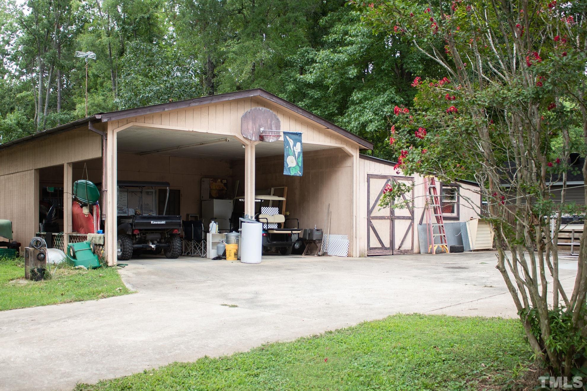 70 Waters Edge Loop Henderson, NC 27537 - Photo 31 of 49 a view of a house with potted plants and a large tree