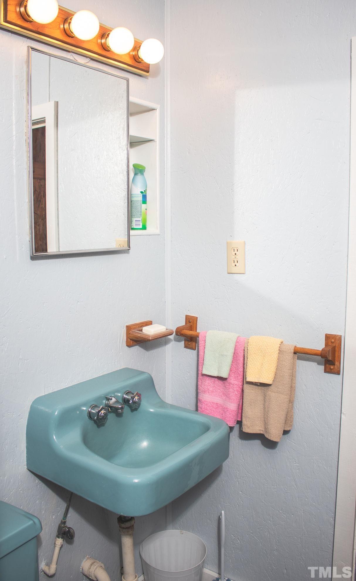 70 Waters Edge Loop Henderson, NC 27537 - Photo 35 of 49 a bathroom with a sink and a mirror