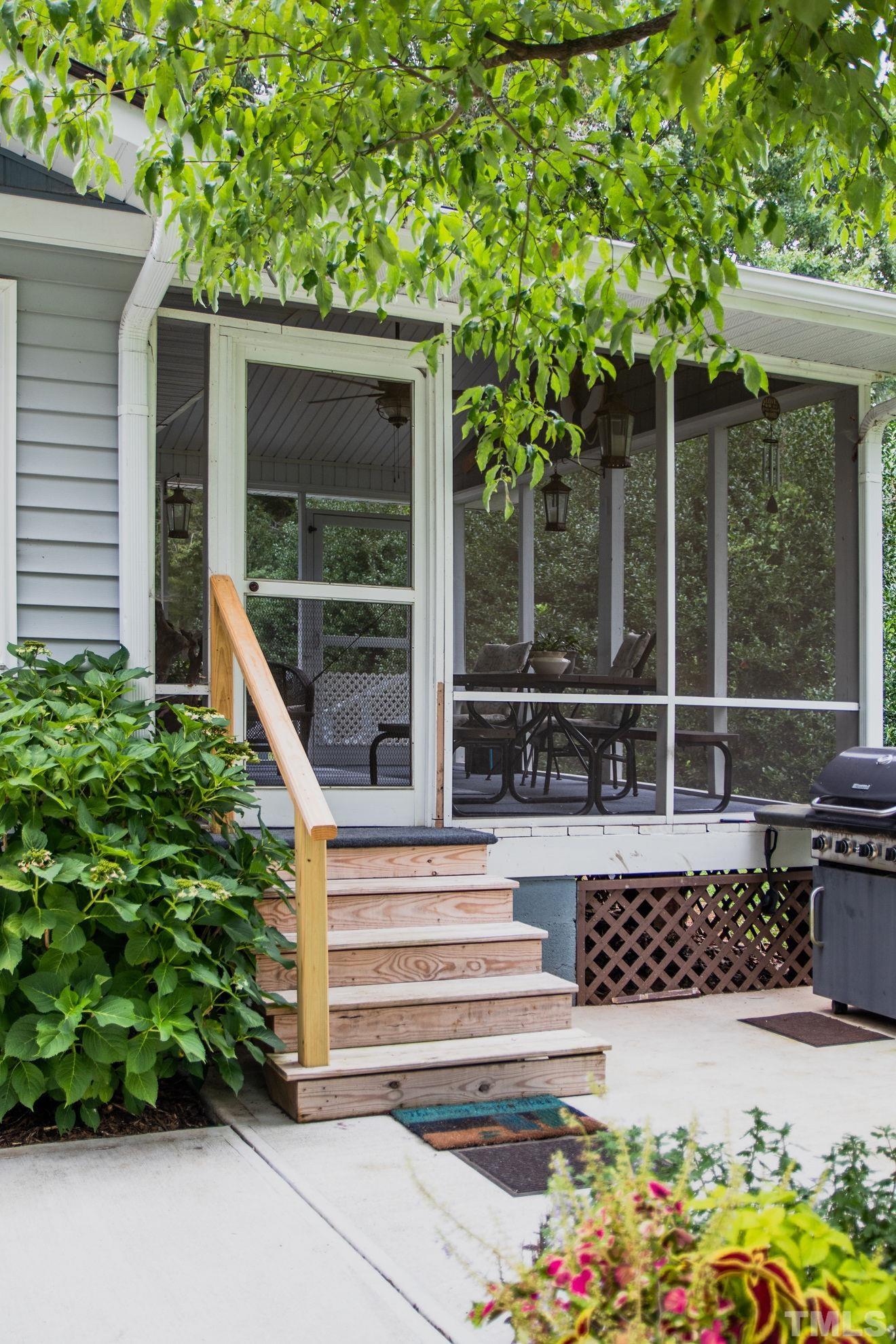 70 Waters Edge Loop Henderson, NC 27537 - Photo 9 of 49 a view of a chair and table in the back yard of the house