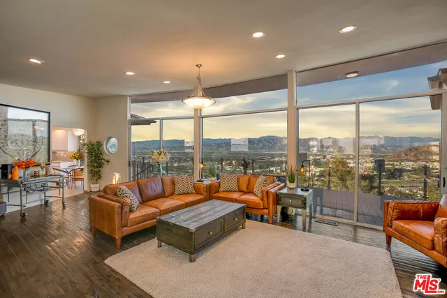 a living room with furniture a rug and a large window