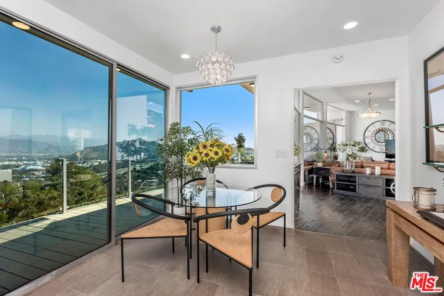 a dining room with furniture a rug and a chandelier
