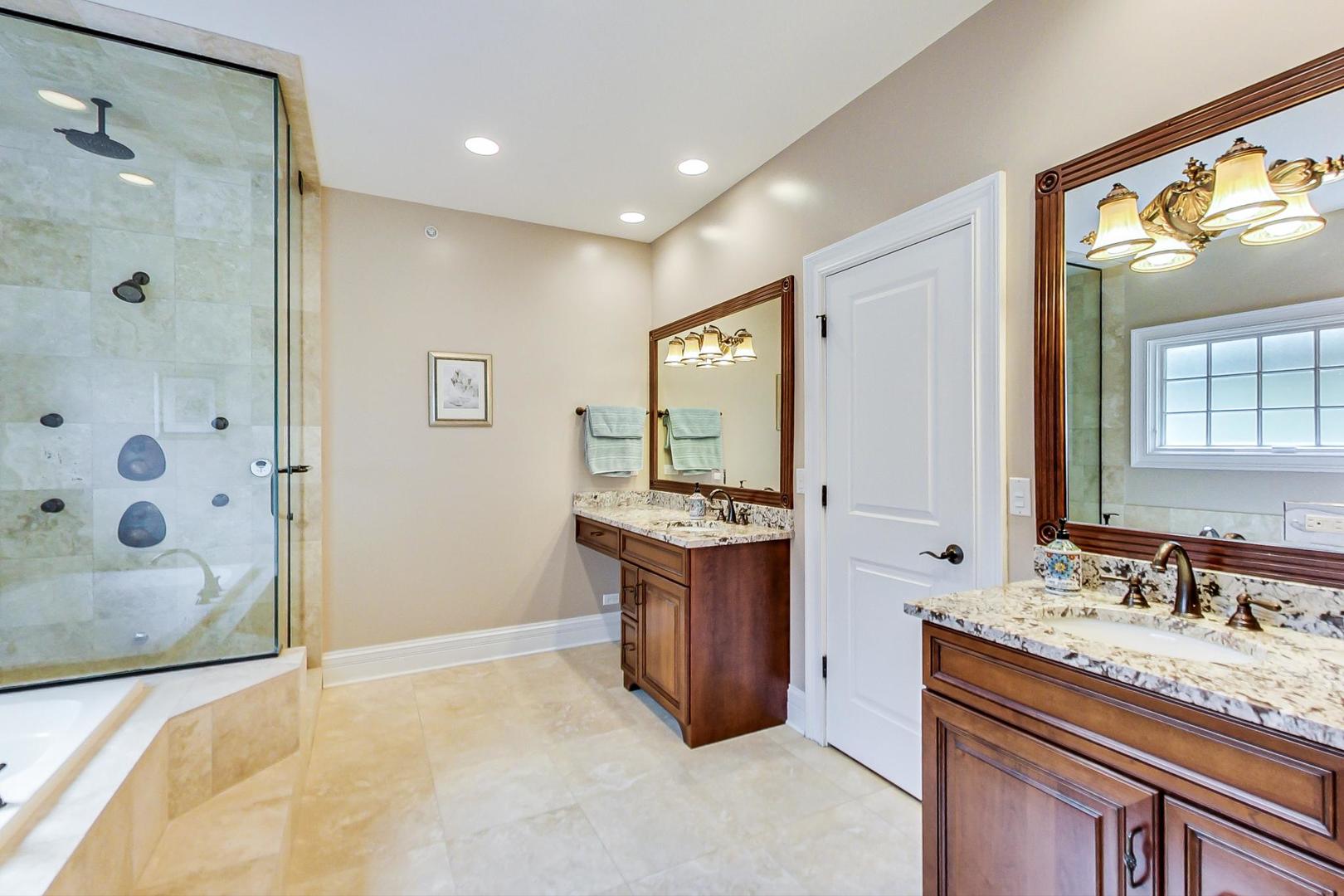 827 South Chester Avenue Park Ridge, IL 60068 - Photo 19 of 38 a spacious bathroom with a granite countertop sink and a mirror