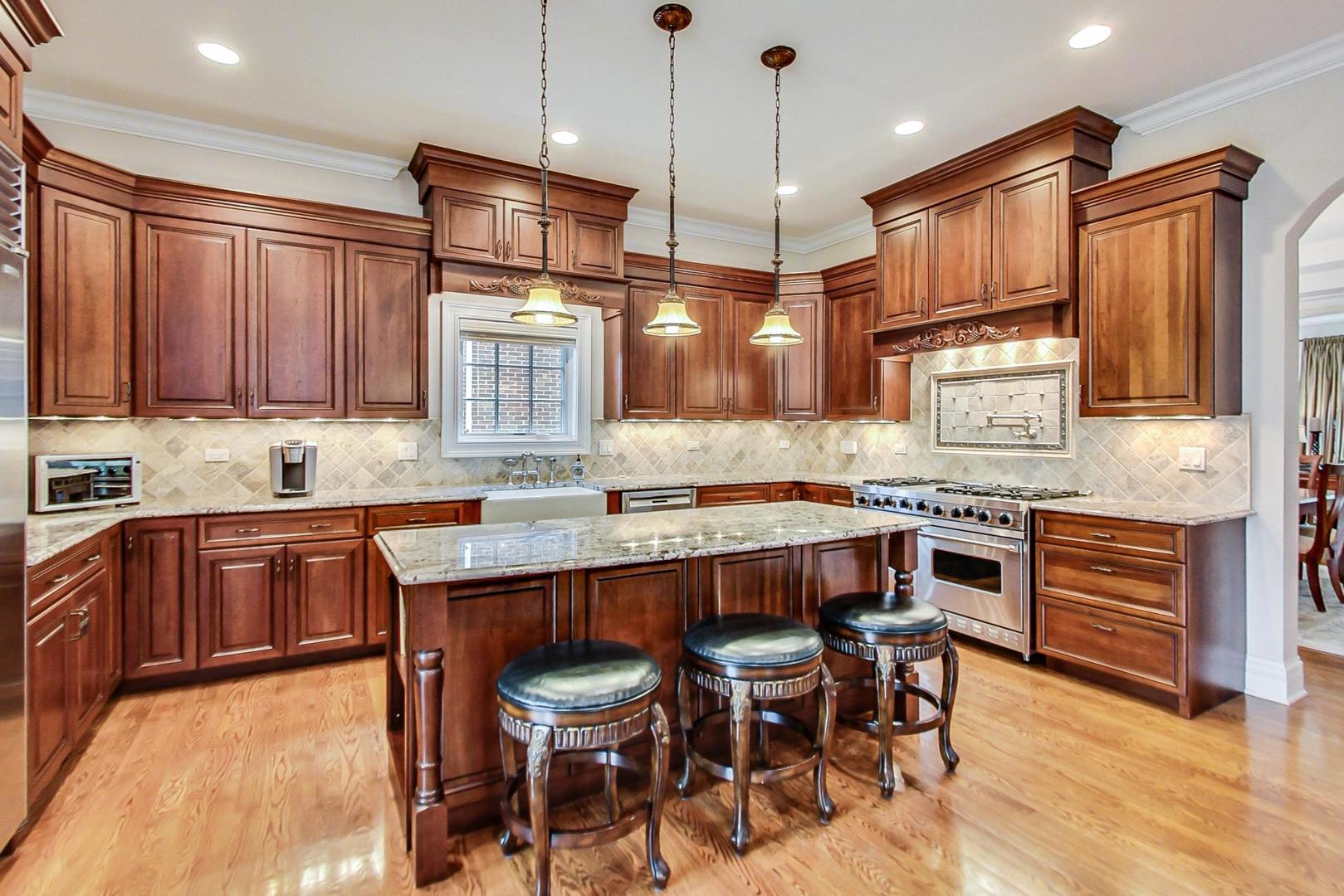 827 South Chester Avenue Park Ridge, IL 60068 - Photo 7 of 38 a kitchen with granite countertop wooden cabinets and stainless steel appliances