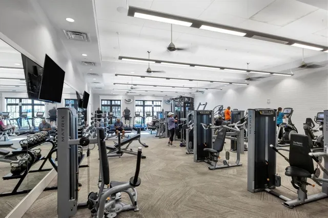 an aerial view of a residential houses with outdoor space and trees