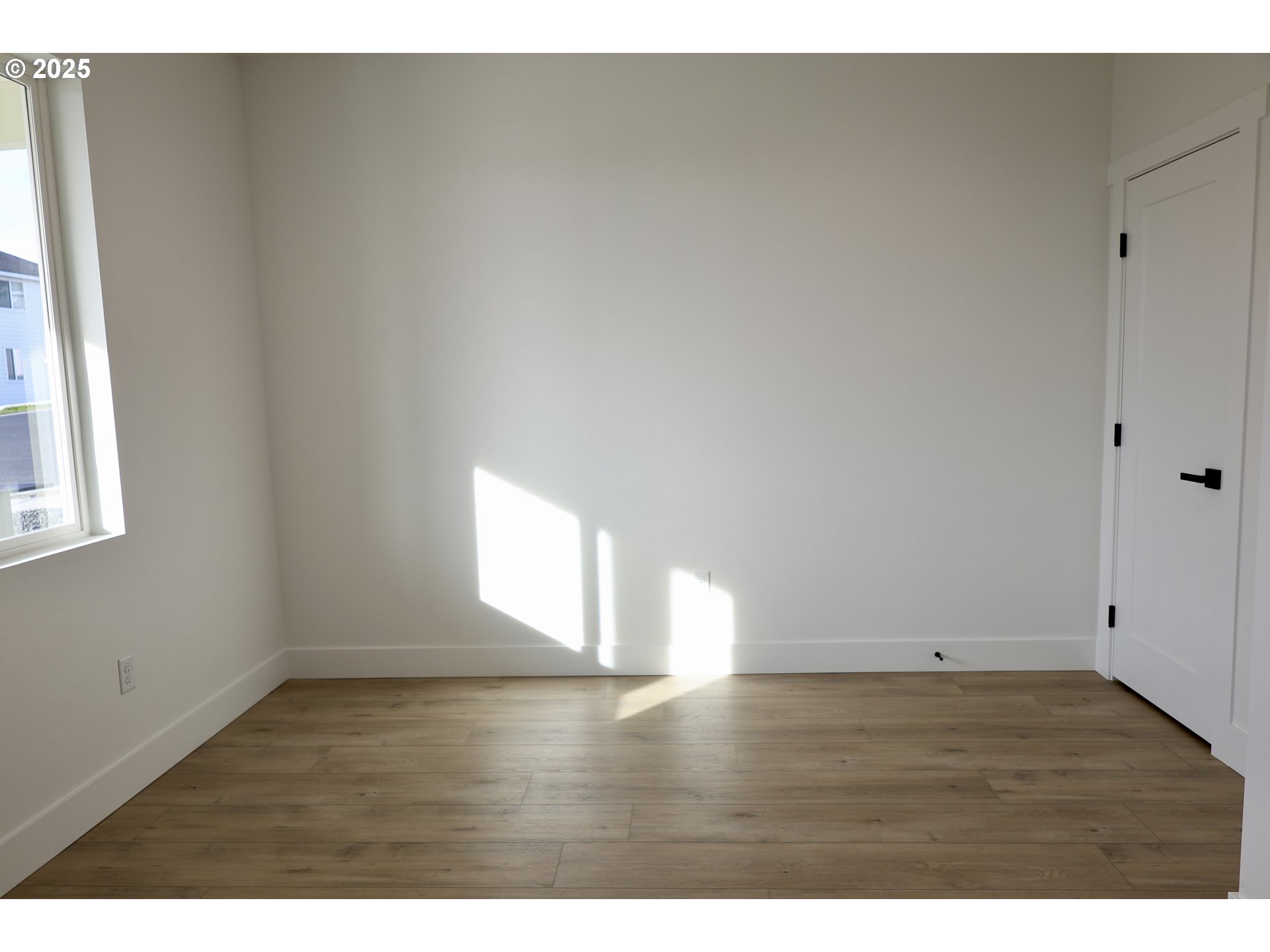 1750 Northeast 8th Place Hermiston, OR 97838 - Photo 4 of 21 a view of an empty room with wooden floor and a window
