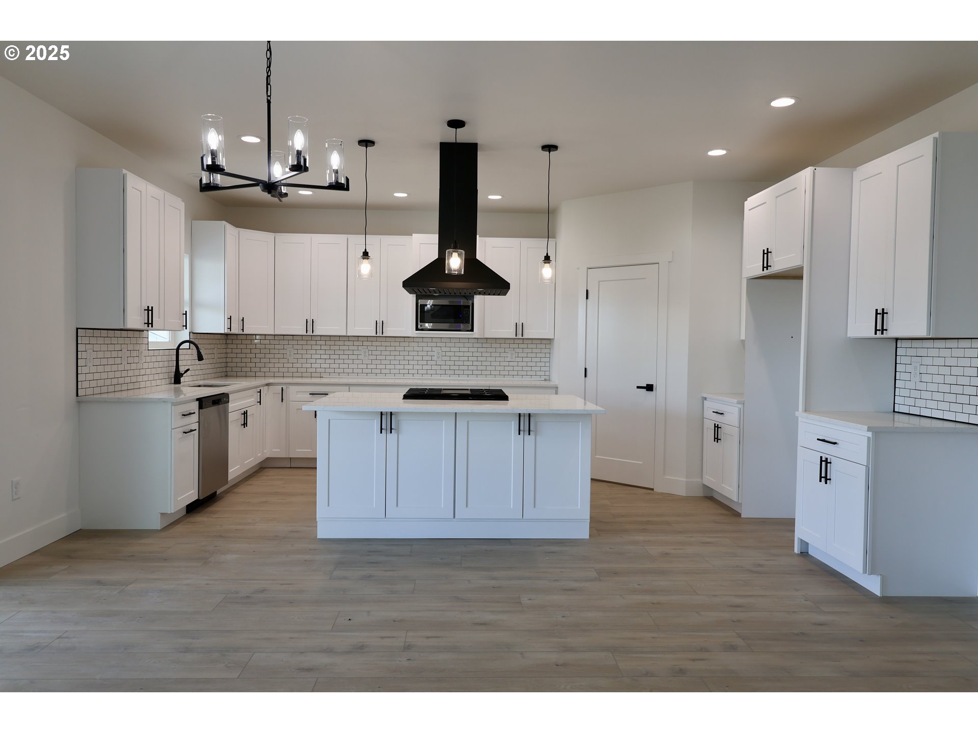 1750 Northeast 8th Place Hermiston, OR 97838 - Photo 7 of 21 a kitchen with kitchen island granite countertop a sink cabinets and stainless steel appliances