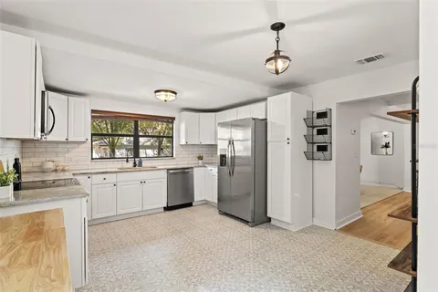 a kitchen with refrigerator cabinets and furniture