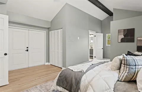 a bedroom with a bed and a flat screen tv