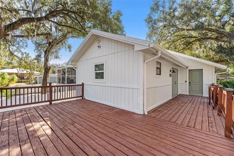 a view of a house with wooden deck