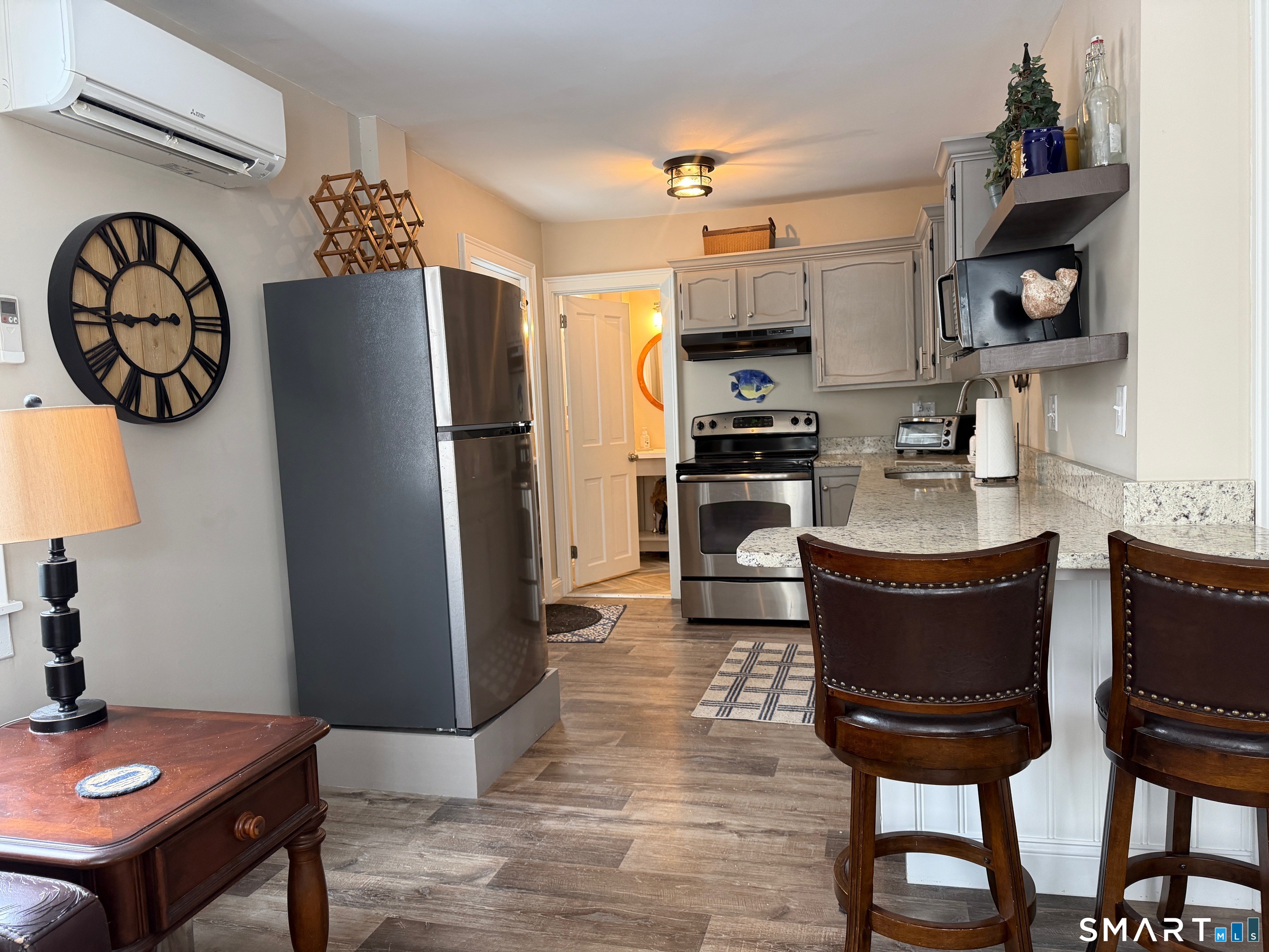 48 Wrights Crossing Road Pomfret, CT 06259 - Photo 2 of 12 a kitchen with stainless steel appliances granite countertop a refrigerator a stove a sink and a dining table with garden view
