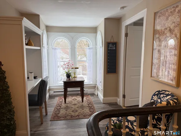 a bedroom with furniture and a window