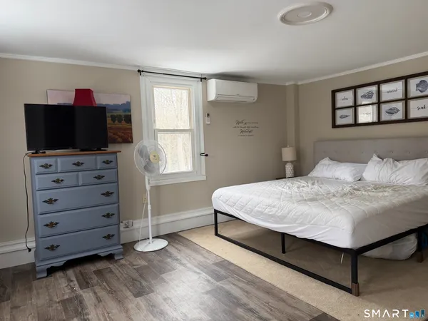 a bedroom with a bed and a flat screen tv