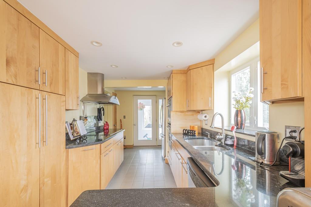 2 Great Rock Road Lexington, MA 02421 - Photo 11 of 42 a large kitchen with sink a refrigerator and cabinets