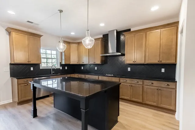 a kitchen with a sink center island cabinets and a window
