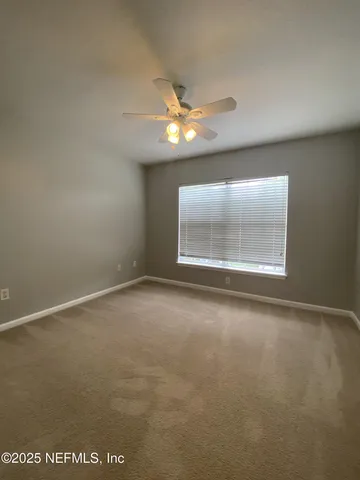 an empty room with a empty space and windows