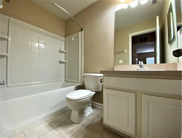 a bathroom with a sink a toilet a mirror and shower