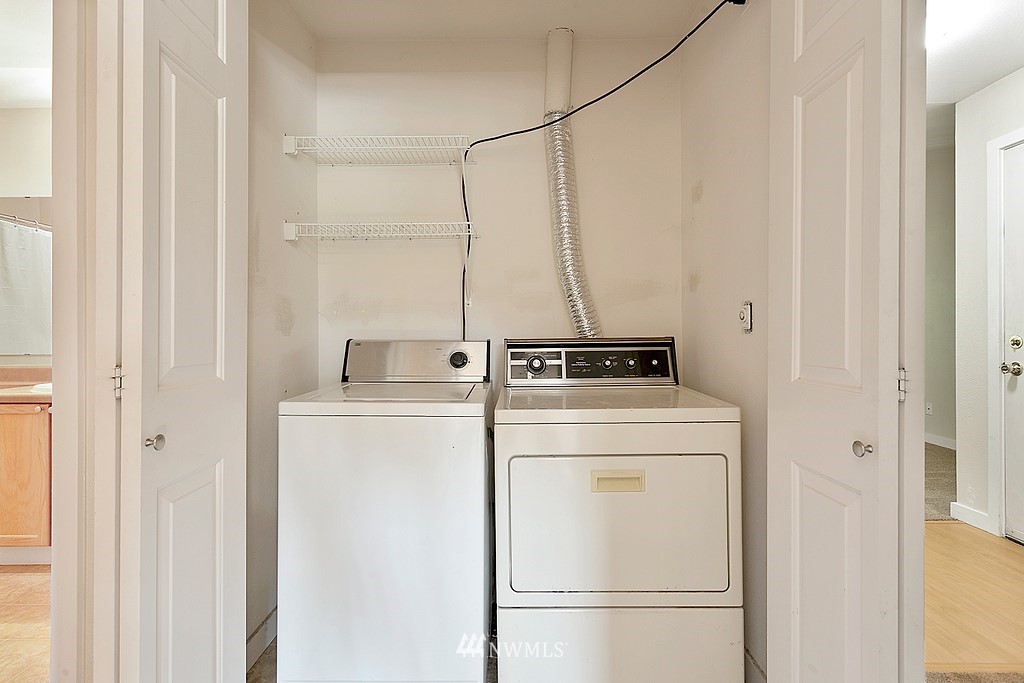 18930 Bothell Everett Highway, Unit C303 Bothell, WA 98012 - Photo 12 of 12 a utility room with dryer and washer