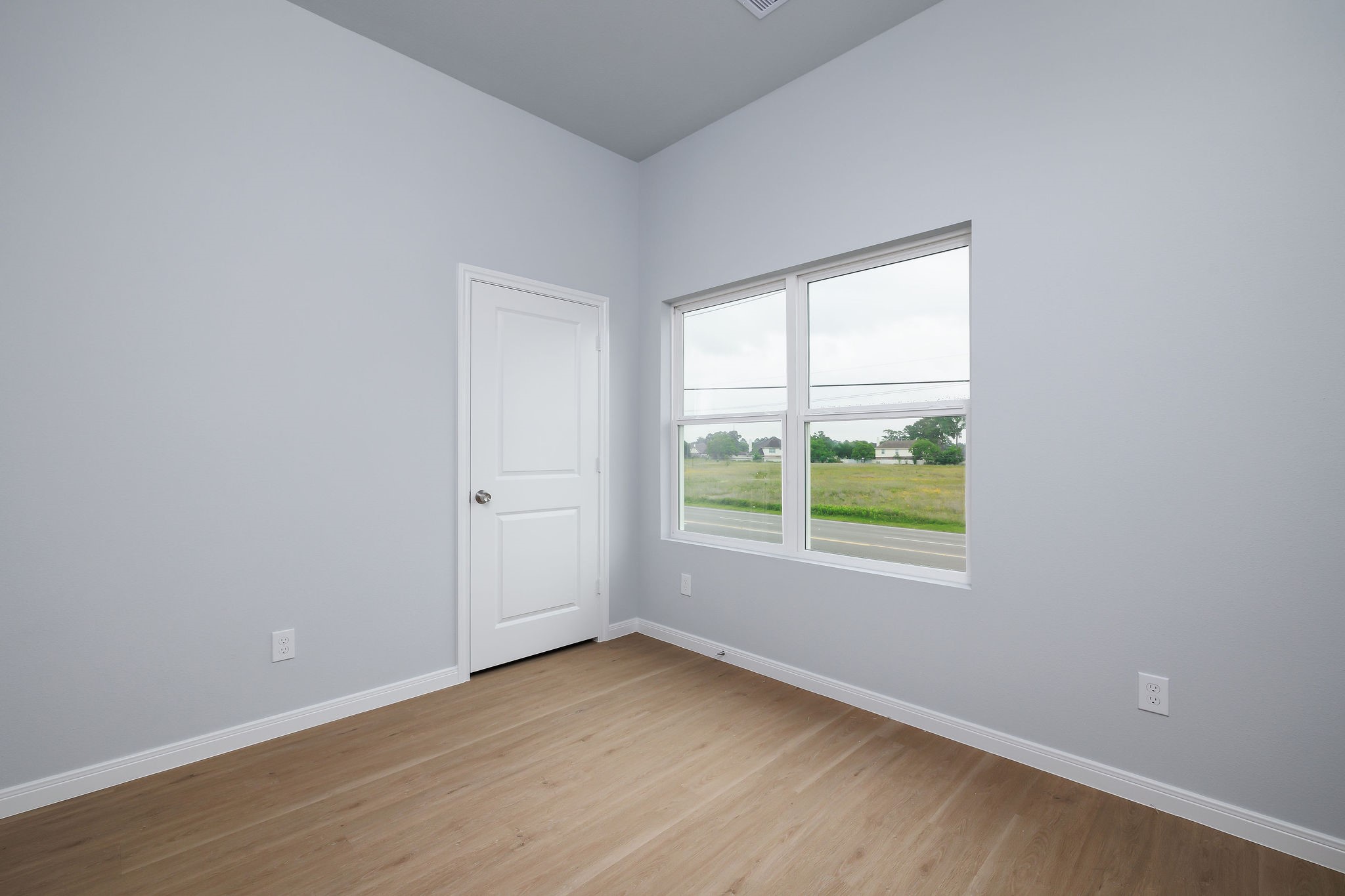 18834 Elegance Ave Spring Spring, TX 77379 - Photo 17 of 19 an empty room with wooden floor and windows