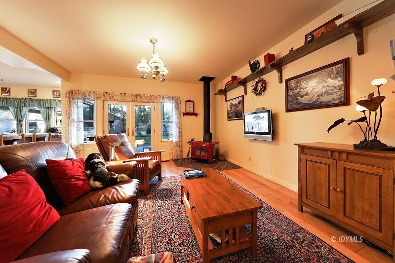 36285 Tool Road Mountain Center, CA 92561 - Photo 19 of 47 a living room with furniture a chandelier and a flat screen tv