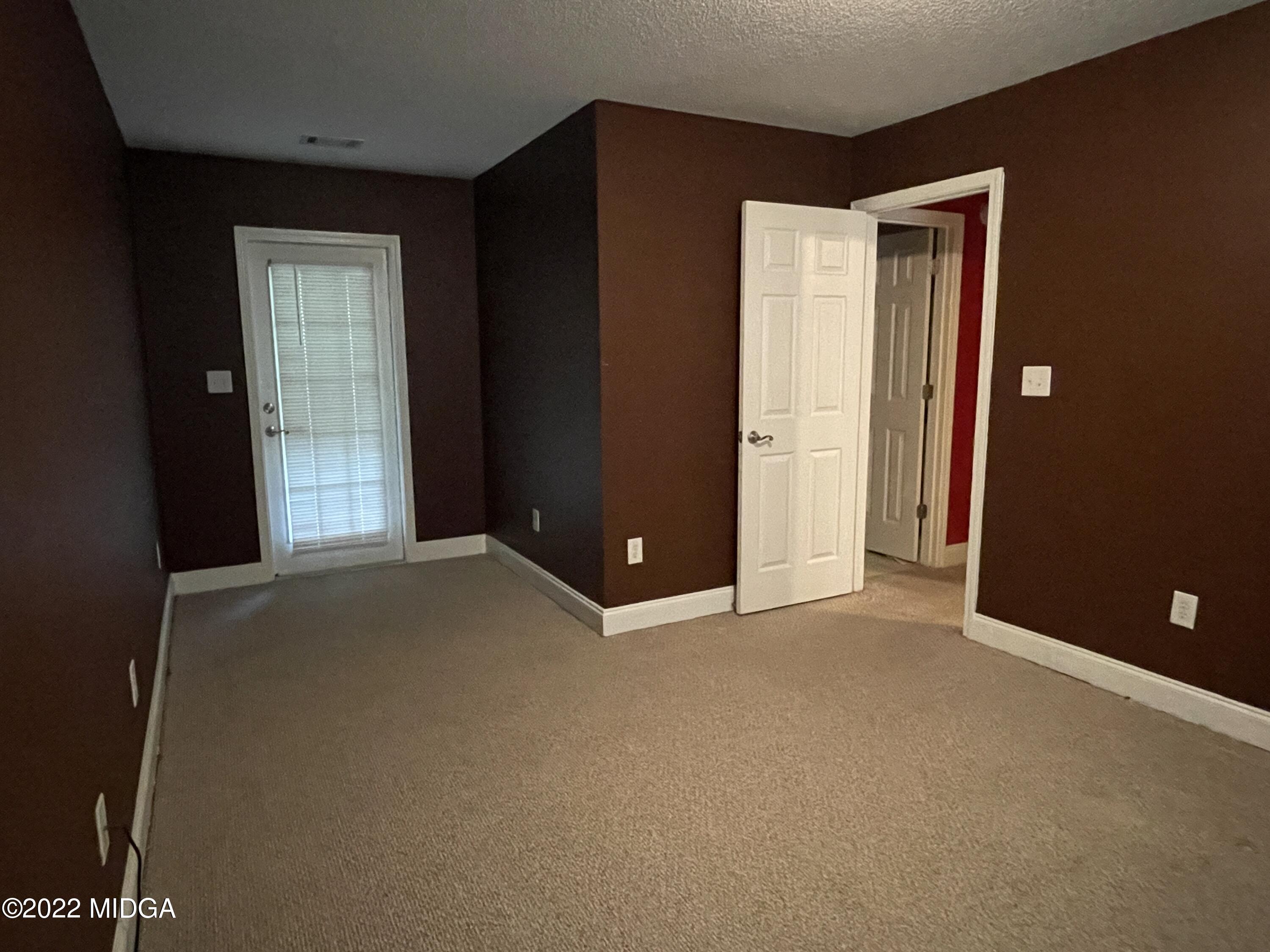 105 Carrs Station Road Sparta, GA 31087 - Photo 16 of 21 an empty room with closet and mirror