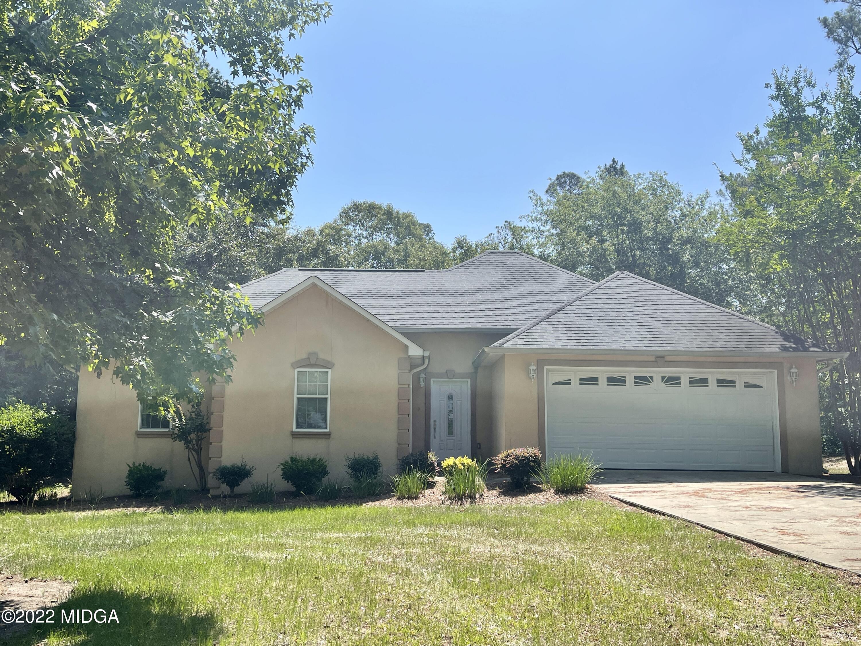 105 Carrs Station Road Sparta, GA 31087 - Photo 2 of 21 a front view of a house with a yard and garage