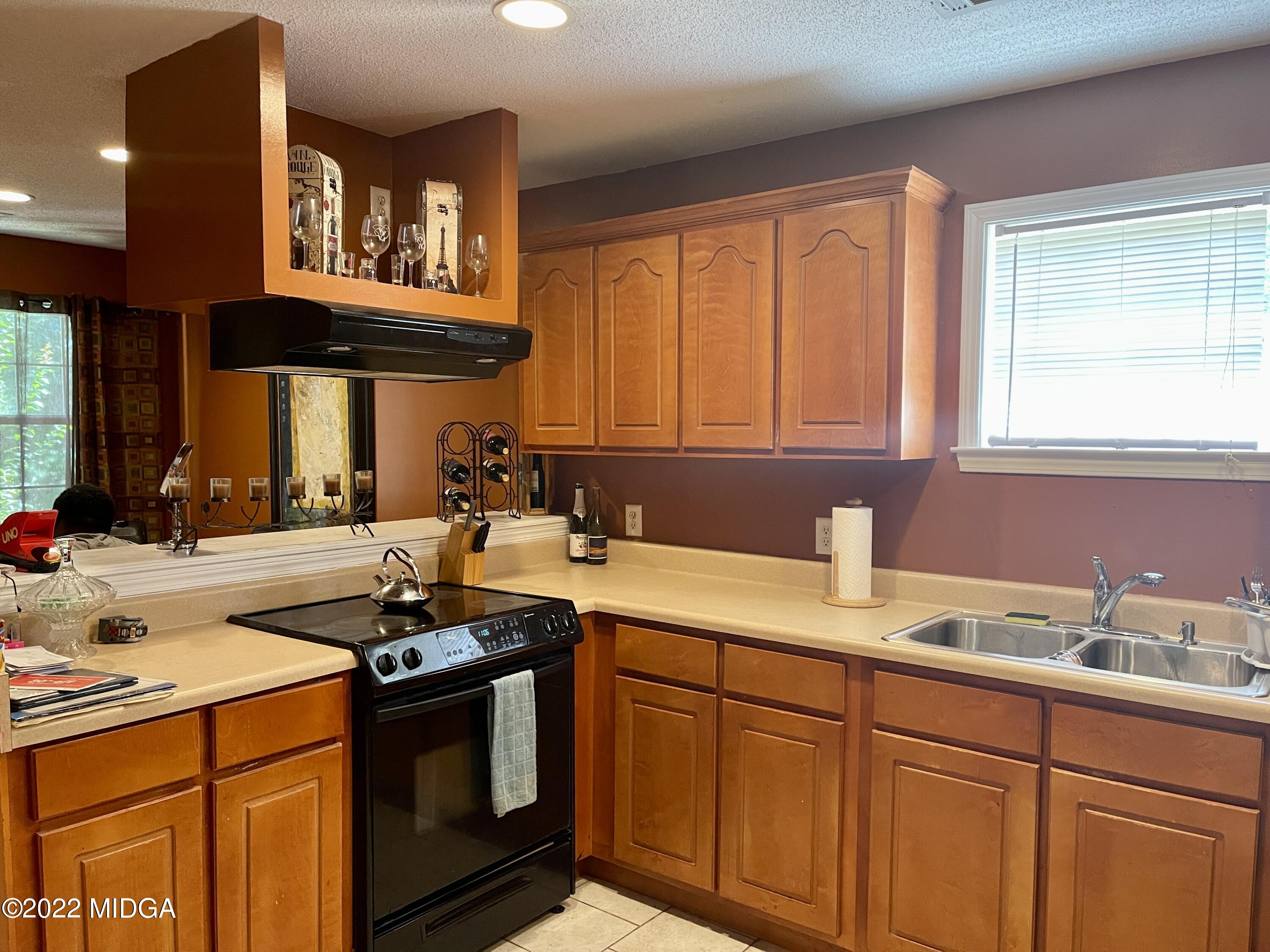 105 Carrs Station Road Sparta, GA 31087 - Photo 7 of 21 a kitchen with stainless steel appliances granite countertop a sink stove and cabinets