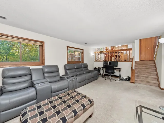 a kitchen with stainless steel appliances granite countertop a sink a stove cabinets dining table and chairs