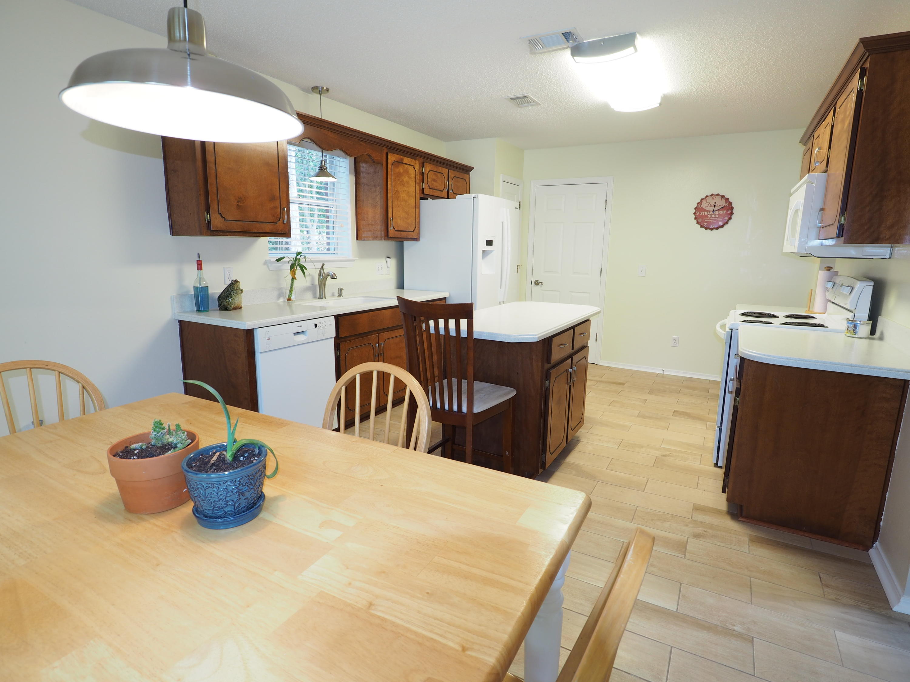 2803 Ram Lane Crestview, FL 32539 - Photo 13 of 35 a kitchen with a table and chairs