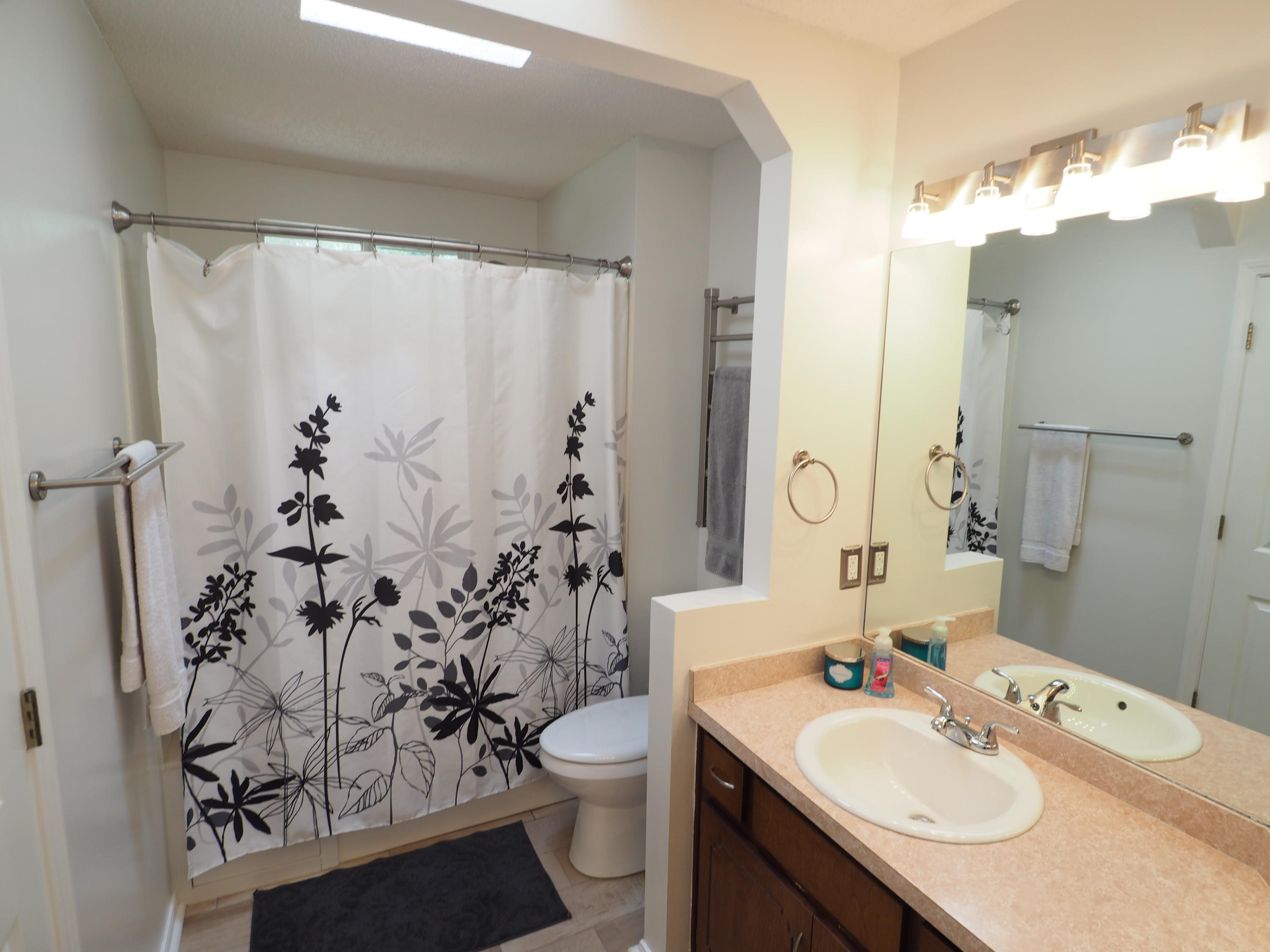 2803 Ram Lane Crestview, FL 32539 - Photo 17 of 35 a bathroom with a sink vanity mirror and toilet