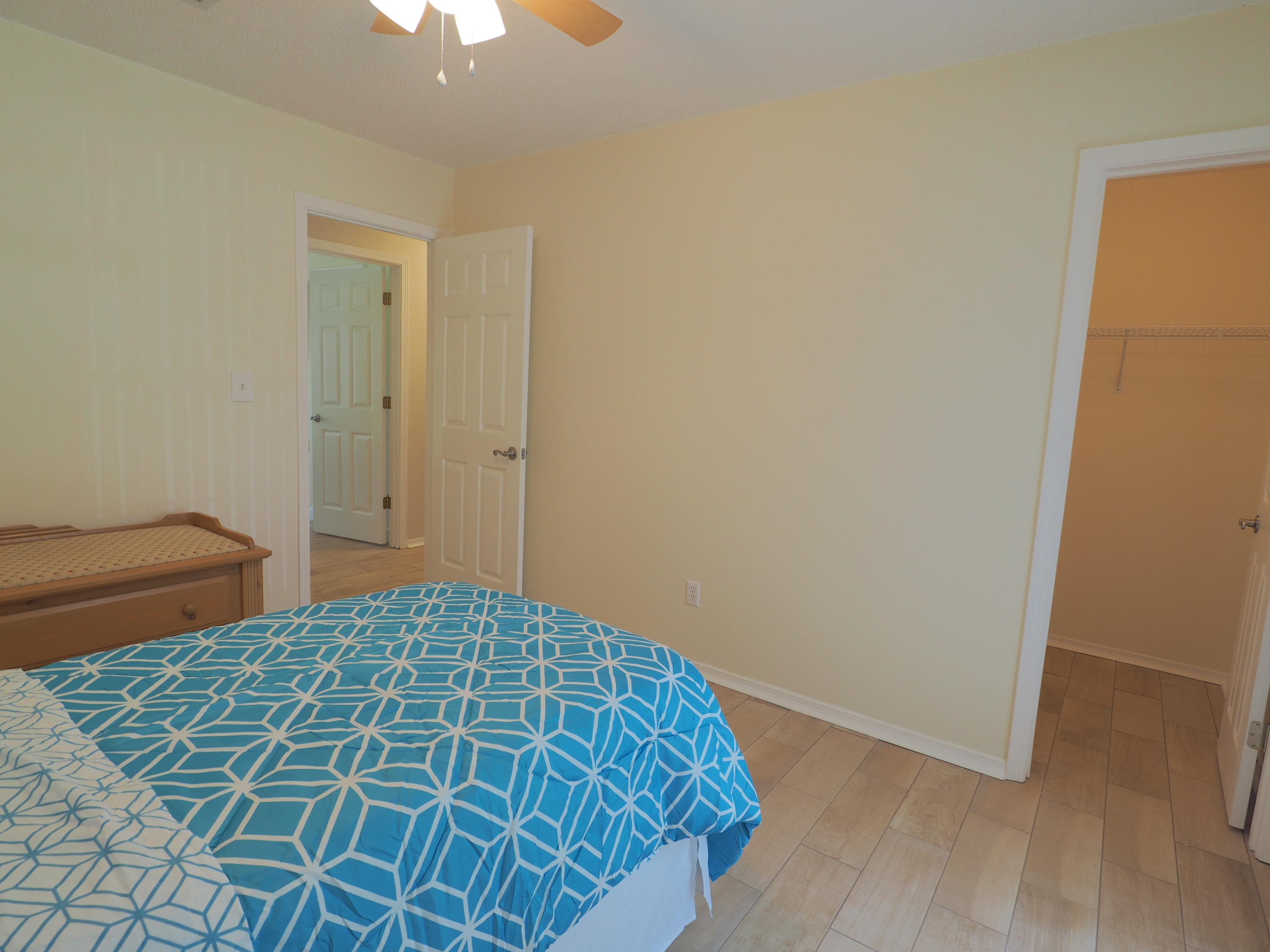 2803 Ram Lane Crestview, FL 32539 - Photo 19 of 35 a bedroom with a bed and a chandelier fan