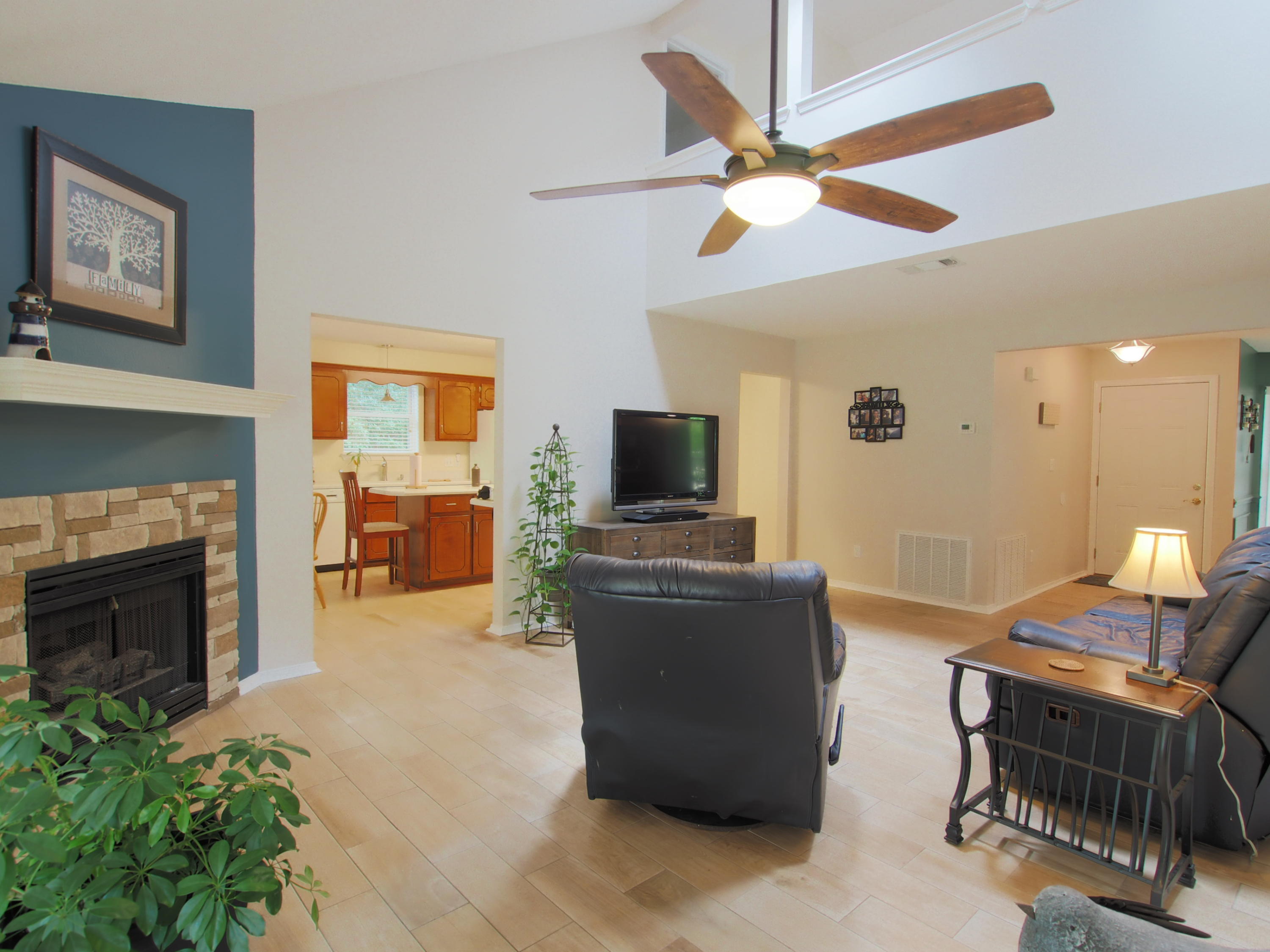 2803 Ram Lane Crestview, FL 32539 - Photo 2 of 35 a living room with furniture a fireplace and a flat screen tv