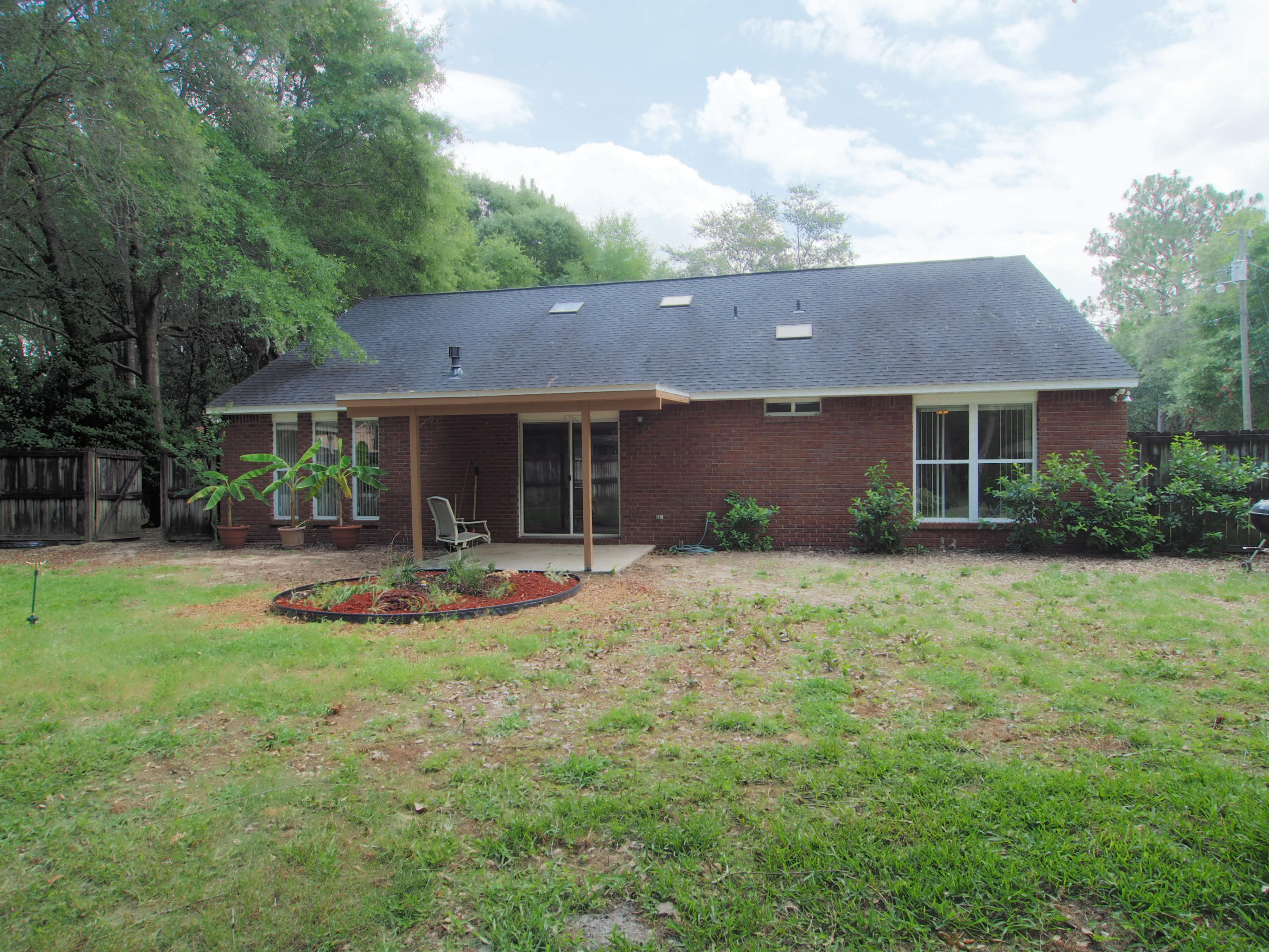 2803 Ram Lane Crestview, FL 32539 - Photo 29 of 35 a front view of a house with a yard and table and chairs