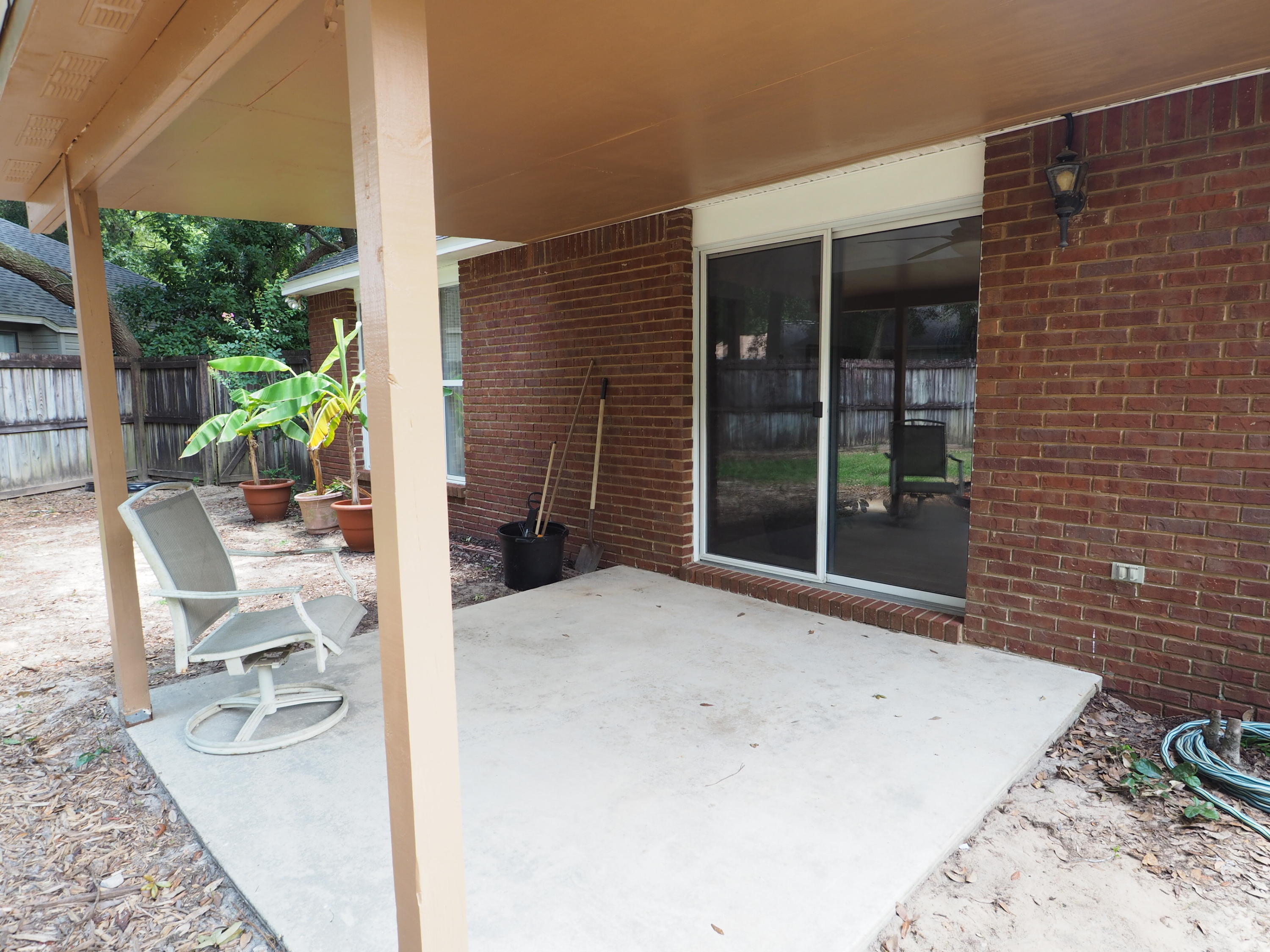 2803 Ram Lane Crestview, FL 32539 - Photo 31 of 35 a view of a patio with table and chairs and potted plants
