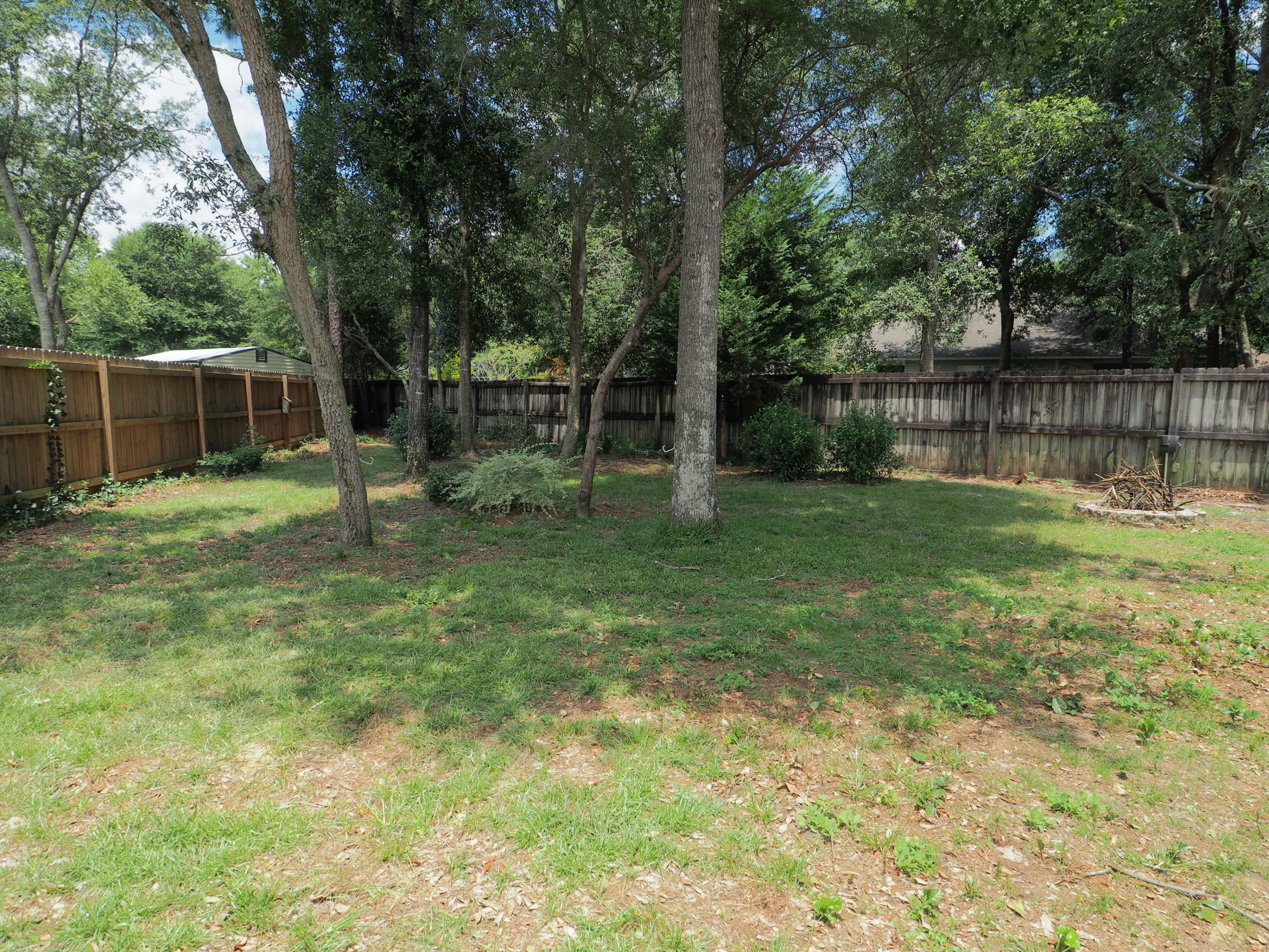 2803 Ram Lane Crestview, FL 32539 - Photo 33 of 35 a backyard of a house with plants and large tree
