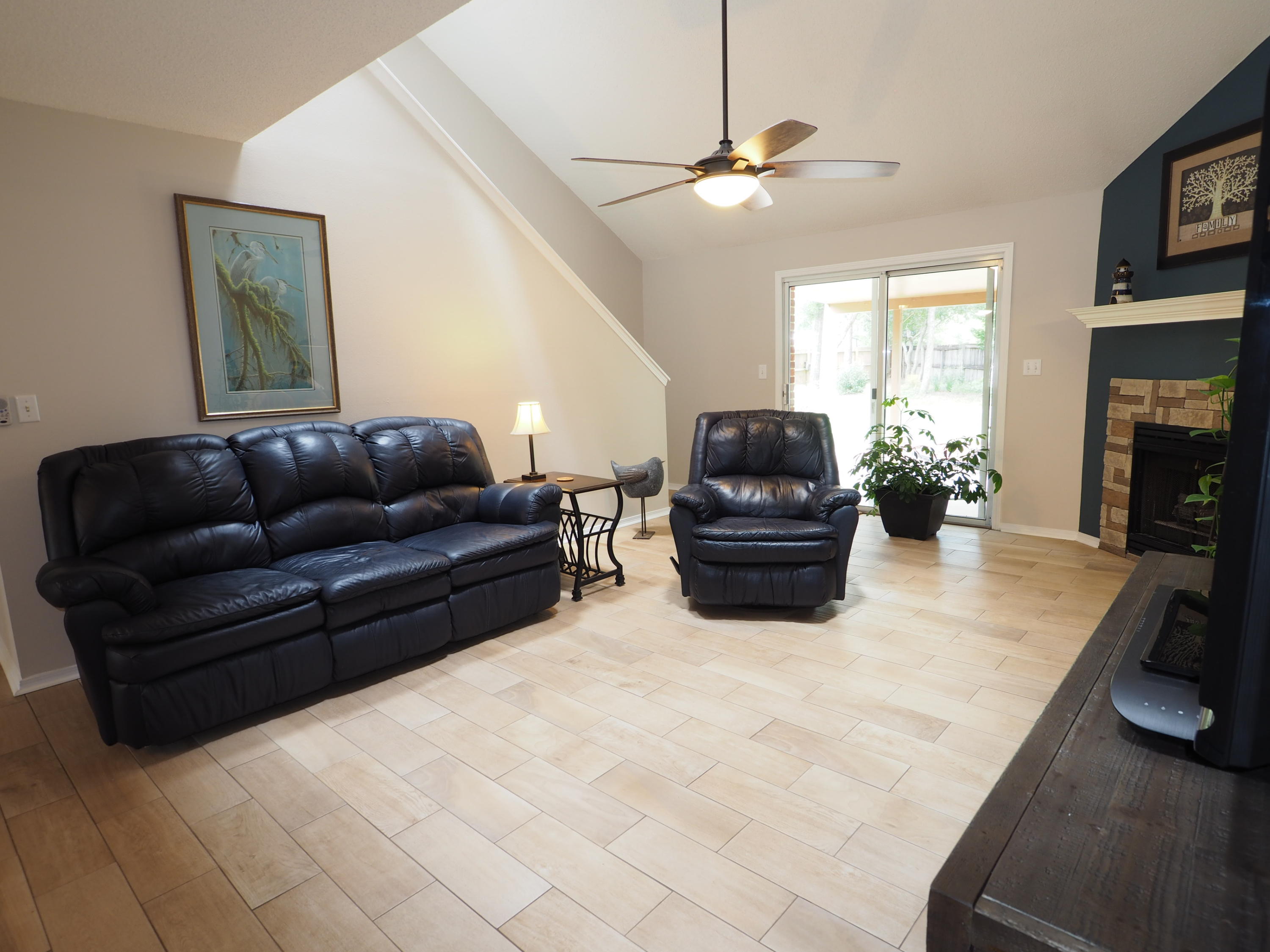 2803 Ram Lane Crestview, FL 32539 - Photo 4 of 35 a living room with furniture a flat screen tv and a fireplace