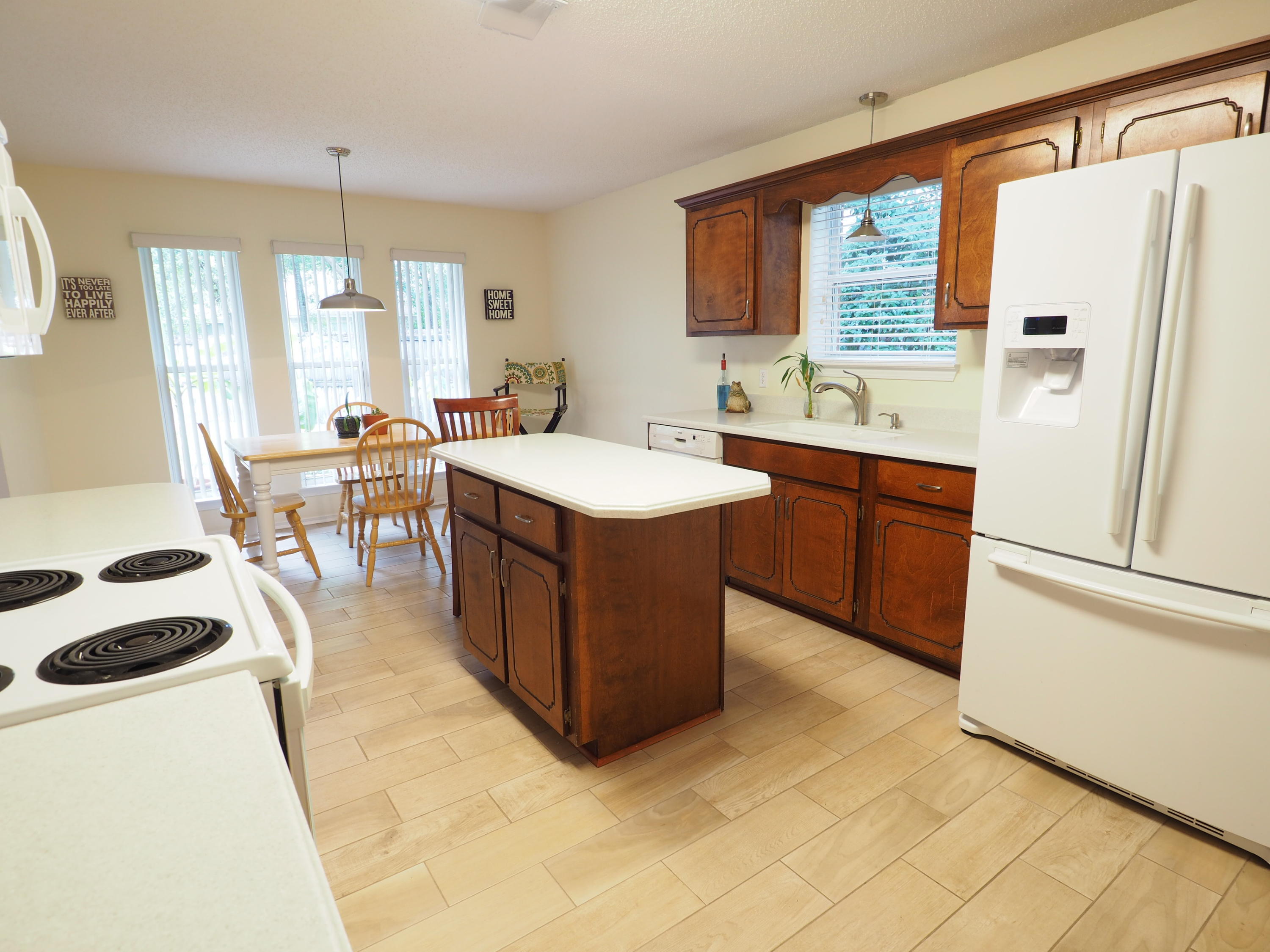 2803 Ram Lane Crestview, FL 32539 - Photo 8 of 35 a kitchen with a sink stove and refrigerator