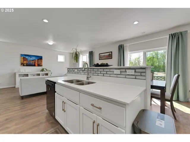 a kitchen with a sink microwave and cabinets
