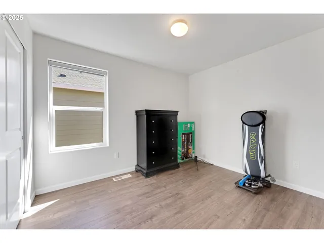 a view of an empty room with closet and a window