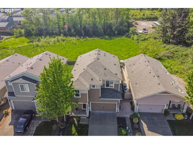an aerial view of a house with garden space and street view