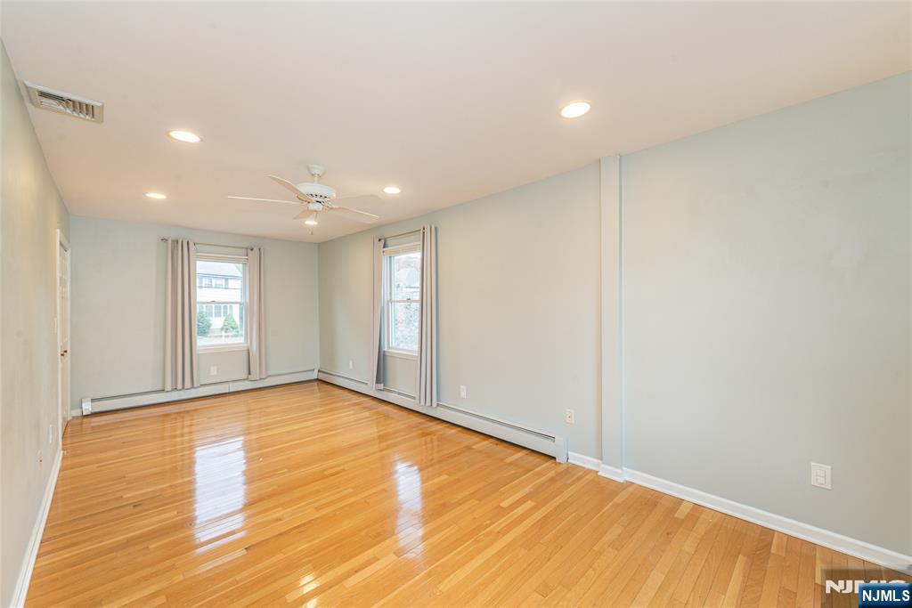 73 Grove Street Clifton, NJ 07013 - Photo 15 of 49 a view of an empty room with wooden floor and a window
