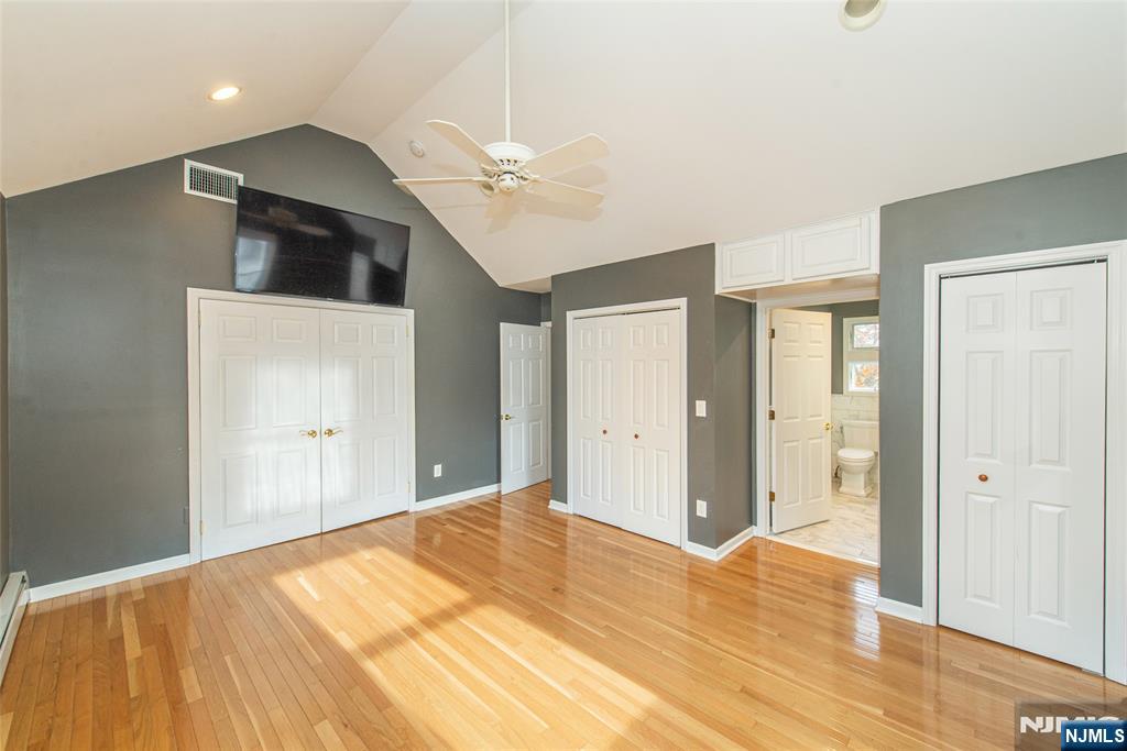 73 Grove Street Clifton, NJ 07013 - Photo 19 of 49 a bedroom with a bed and a chandelier