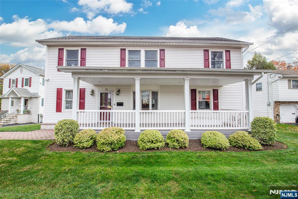 73 Grove Street Clifton, NJ 07013 - Photo 2 of 49 a front view of a house with a garden