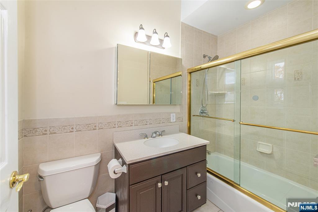 73 Grove Street Clifton, NJ 07013 - Photo 22 of 49 a bathroom with a sink toilet and shower