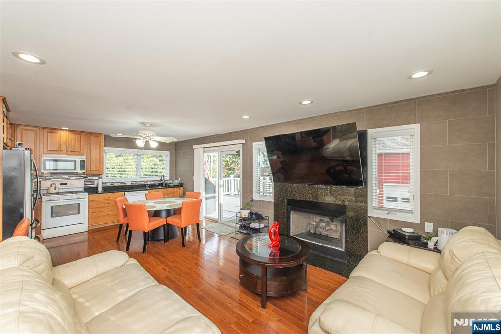 73 Grove Street Clifton, NJ 07013 - Photo 33 of 49 a living room with furniture a flat screen tv and a fireplace